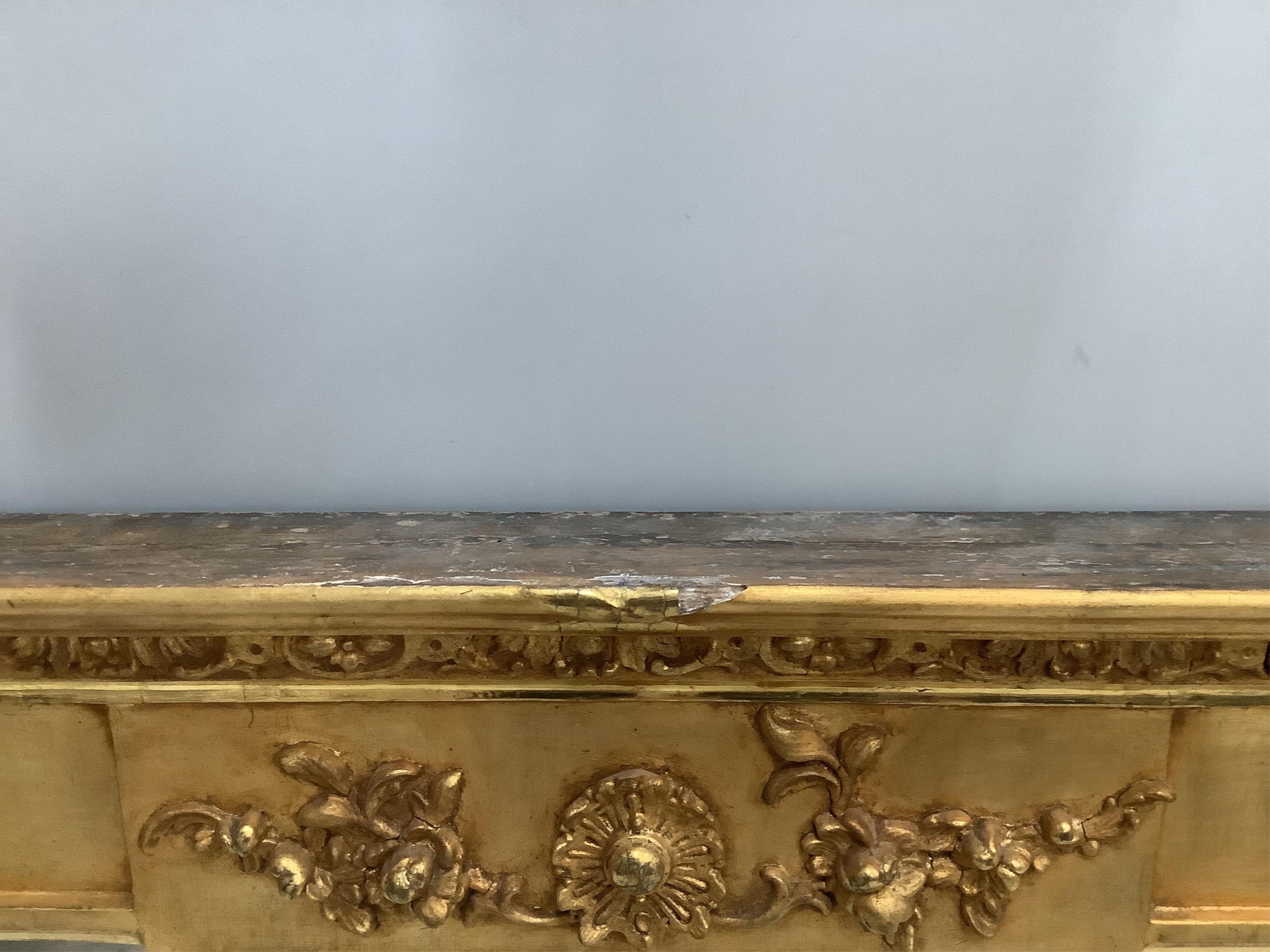 A Regency giltwood and composition overmantel mirror, width 193cm, height 81cm. Condition - fair